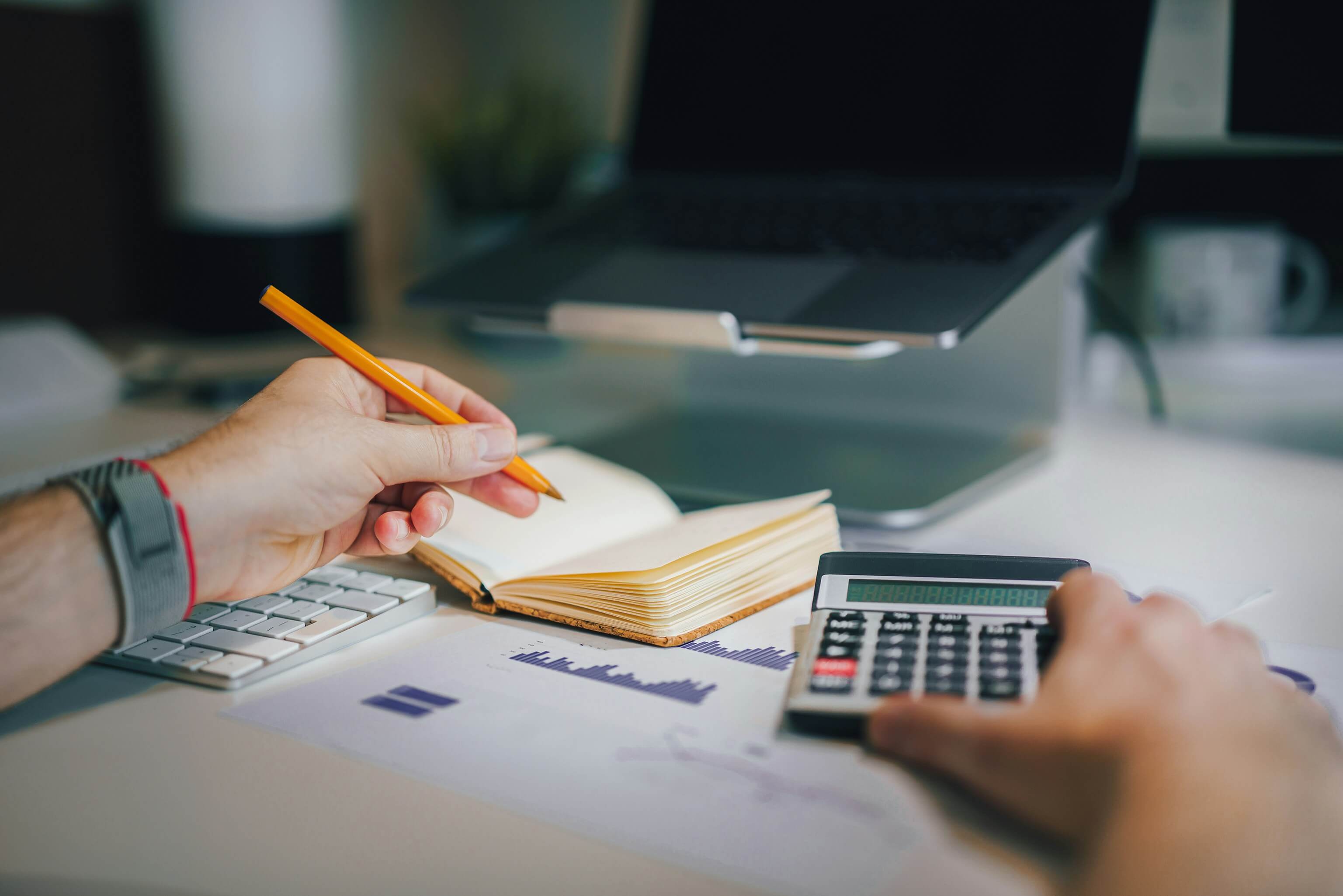 A person at a desk with a calculator, pet supplies
